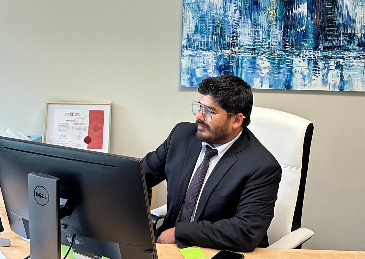 Sahil Mahajan at his desk at the Immigration Mart office
