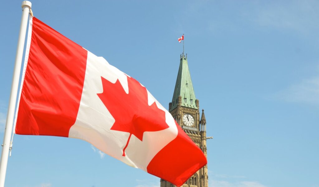 The Canadian flag flying by the Peace Tower on Parliament Hill