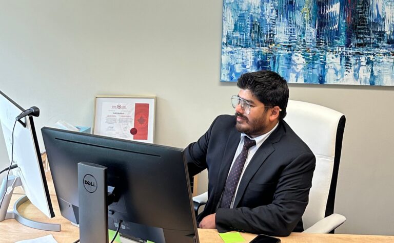 Sahil Mahajan at his desk at the Immigration Mart office