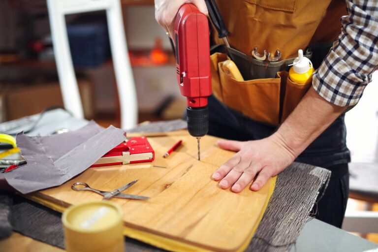 A tradesperson working with tools at a bench